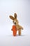 Little brown Plush Rabbit posing with a carrot