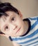 Little brunette boy wearing striped shirt indoor