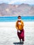 Little buddhist monk wearing Covid mask near beautiful Pangong lake