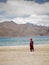 Little buddhist monk wearing Covid mask near beautiful Pangong lake