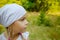 Little calm girl in white scarf in profile