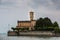 Little castle with round tower near the lake