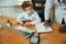 Little caucasian boy as a doctor consulting for patient, working in cabinet, close up