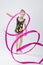 Little Caucasian Female Rhythmic Gymnast In Professional Competitive Suit Doing Artistic Ribbon Spirals