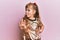 Little caucasian girl kid wearing festive sequins dress doing stop sing with palm of the hand