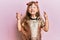 Little caucasian girl kid wearing festive sequins dress gesturing finger crossed smiling with hope and eyes closed