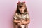 Little caucasian girl kid wearing festive sequins dress with hand on stomach because indigestion, painful illness feeling unwell