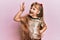 Little caucasian girl kid wearing festive sequins dress smiling positive doing ok sign with hand and fingers