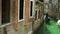 Little channel `street` with unfocused gondola. Venice, Italy