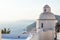 Little chapel `Agios Minas` during last sun along the ocean, Fira, Santorini, Greece