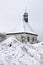 Little chapel over the large snow drift