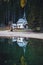 Little chapel reflecting in Lago di Braies in fall, Dolomites, South Tyrol, Italy