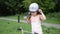 Little charming girl child puts on a bicycle helmet for cycling