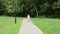 Little charming girl child rides a bicycle in the park