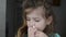 Little charming girl child sprays a runny nose spray in her nose