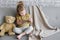 Little charming girl sits on a gray sofa.