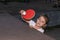 Little charming happy girl child plays ping pong on the street