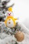 Little charming snowman and toy ball on snow-covered Christmas t