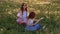 Little cheerful sisters play guitar on outdoors dandelions field, Evening time, Happy childhood.concept Freedom and entertainment.