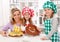 Little chef girls with their mother making a cake