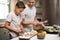 Little chef in the making. a young boy helping his father cook in the kitchen.