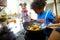 Little Chefs in Action: Boy and Girl Playfully Cooking Vegetables in the Kitchen