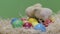 Little chickens playing on colorful easter eggs. Green background. Fluffy chick