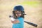 Little child baseball player focused ready to bat. Kid holding a baseball bat.