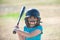 Little child baseball player focused ready to bat. Kid holding a baseball bat.