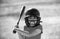 Little child baseball player focused ready to bat. Kid holding a baseball bat.