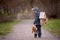 Little child, blond boy with pet dog, carying home on his back, kid, having paper house