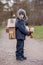 Little child, blond boy with pet dog, carying home on his back, kid, having paper house