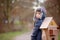 Little child, blond boy with pet dog, carying home on his back, kid, having paper house