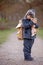 Little child, blond boy with pet dog, carying home on his back, kid, having paper house