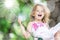 Little child blond girl having fun on a swing