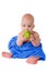 Little child in a blue towel biting green ball