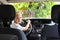 Little child boy behind the steering wheel of a car