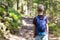 Little child boy with hikers backpack travelling in forest