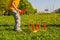 Little child boy playing. Ring throw summer game on a green lawn in the sun