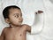 little child with broken or fractured arm with plaster bandage on white background