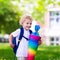 Little child with candy cone on first school day