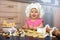 Little child chief cooking cookies in the kitchen