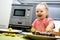 Little child chief cooking cookies in the kitchen