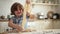 Little child cooks in kitchen boy holds piece of raw dough