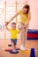 Little child doing steps on fitness plate in the gym