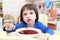 Little child eats tasty red soup