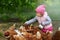 Little child enjoying feeding chicken