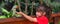 Little child feeds a Alexandrine Parrot