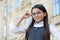 Little child fix round-framed eye glasses wearing formal school uniform outdoors, vision. formal education