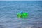 A little child floats on an rubber ring in the middle of the sea alone